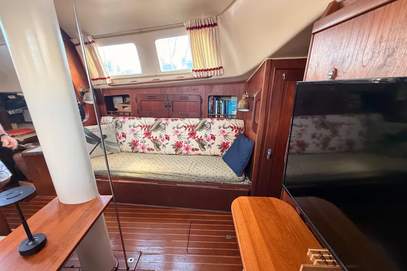 Slide: The Image of Interior of a 1978 Morgan 452 sailboat with floral upholstery and wooden furnishings. - 4
