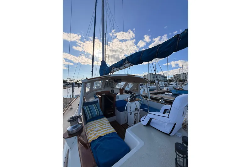 Slide: The Image of 1978 Morgan 452 sailboat interior with blue and white seating, docked at marina. - 44
