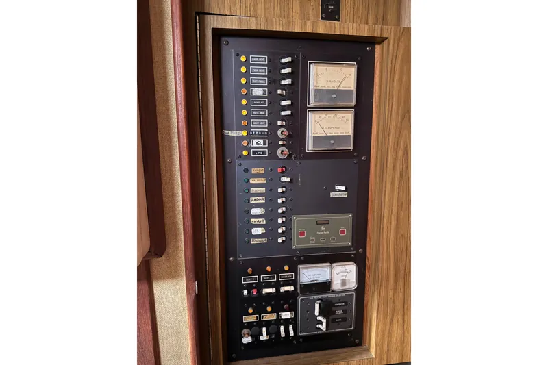 Slide: The Image of 1978 Morgan 452 control panel with gauges and switches on a wooden background. - 48