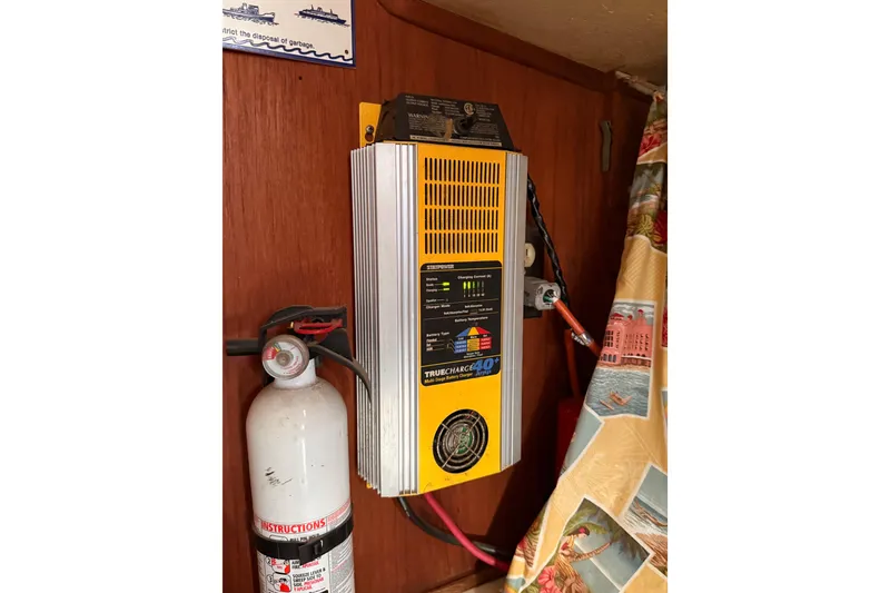 Slide: The Image of 1978 Morgan 452 interior with battery charger and fire extinguisher mounted on wooden panel. - 49