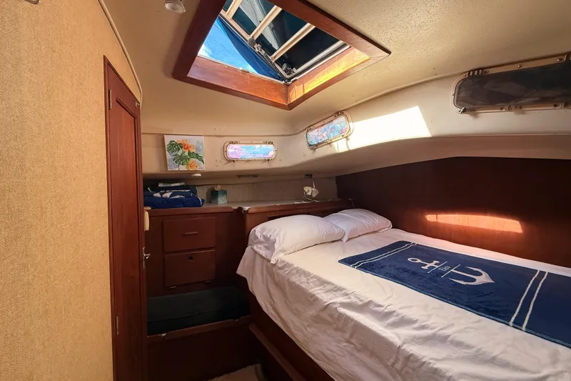 Slide: The Image of Cozy cabin interior of a 1978 Morgan 452 sailboat with skylight and nautical decor. - 5