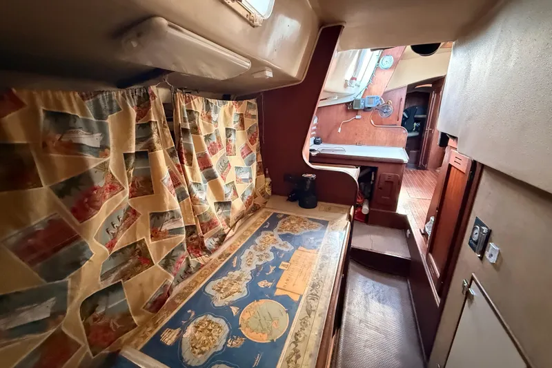 Slide: The Image of Interior of a 1978 Morgan 452 sailboat with nautical decor and vintage map table. - 50