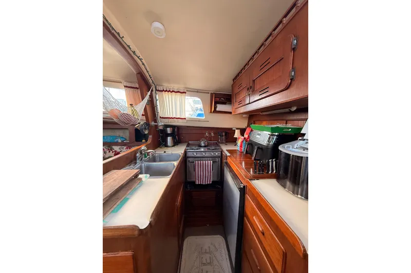 Slide: The Image of 1978 Morgan 452 yacht kitchen interior with wooden cabinets and modern appliances. - 52