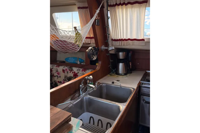 Slide: The Image of 1978 Morgan 452 yacht kitchen with sink, hammock, and coffee maker. - 54