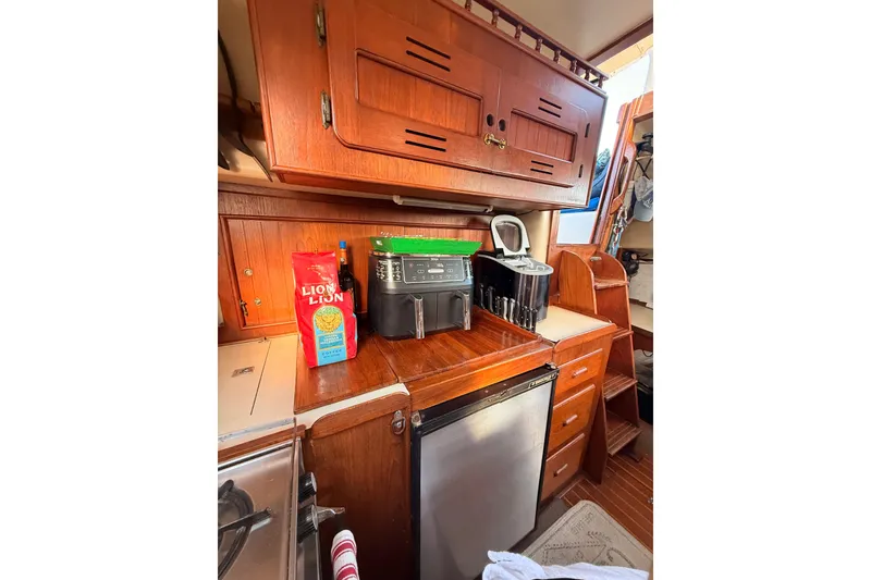 Slide: The Image of 1978 Morgan 452 yacht interior kitchen with wooden cabinets and modern appliances. - 55