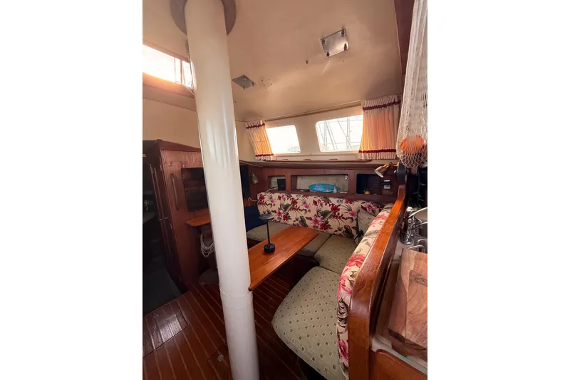 Slide: The Image of Interior of a 1978 Morgan 452 sailboat with floral upholstery and wooden accents. - 56