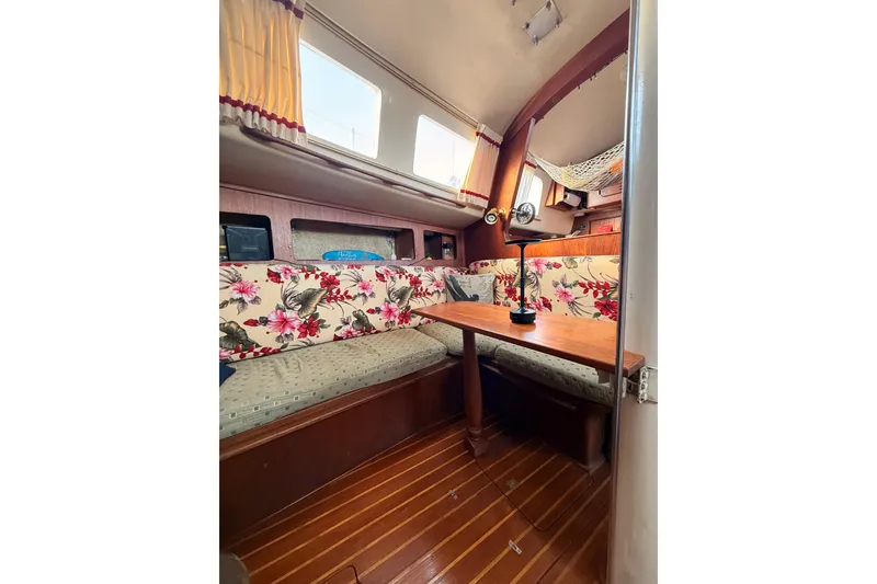 Slide: The Image of Interior of a 1978 Morgan 452 sailboat with floral upholstery and wooden table. - 58