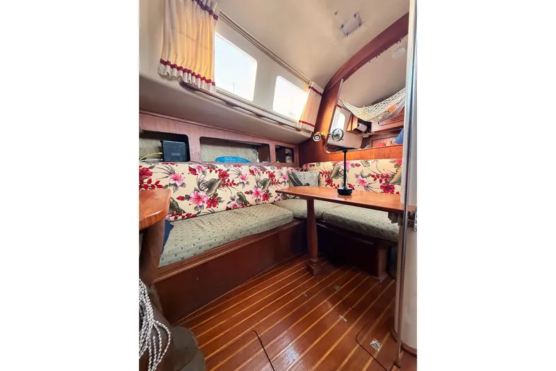 Slide: The Image of Interior of a 1978 Morgan 452 sailboat with floral upholstery and wooden flooring. - 59