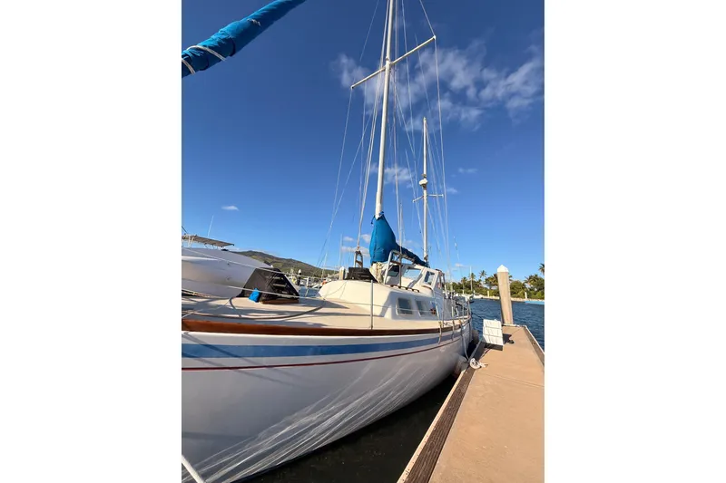 Slide: The Image of 1978 Morgan 452 sailboat docked under clear blue sky. - 60