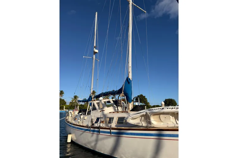 Slide: The Image of 1978 Morgan 452 sailboat docked under clear blue sky. - 64