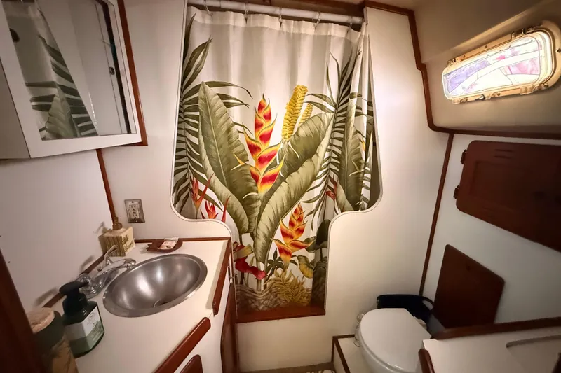 Slide: The Image of 1978 Morgan 452 yacht bathroom with tropical shower curtain and stainless steel sink. - 7