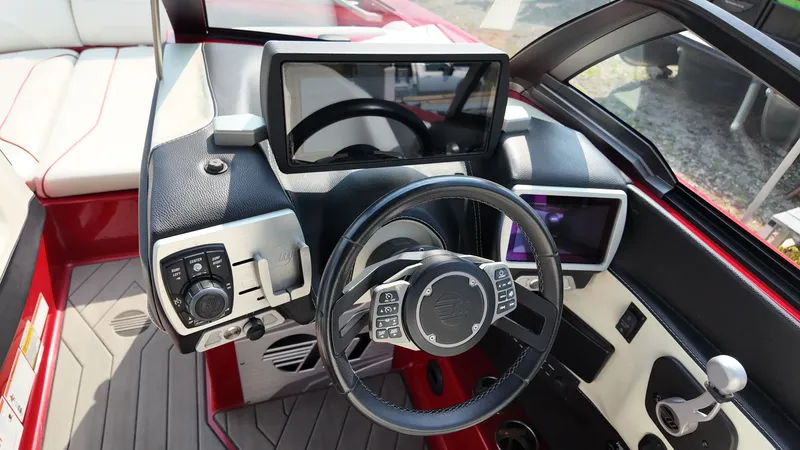 Slide: The Image of 2017 Malibu Wakesetter 24 MXZ interior with steering and displays. - 8