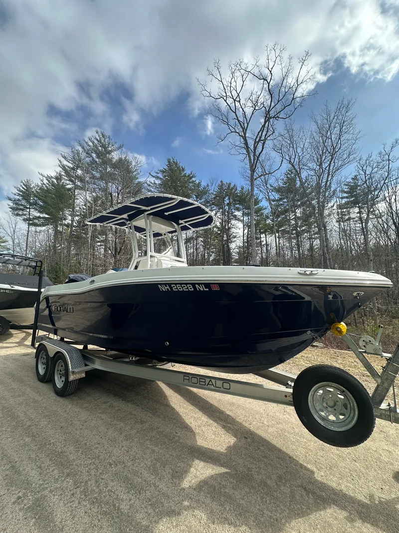 The Image of 2023 Robalo R202 Explorer boat on trailer outdoors. - 1