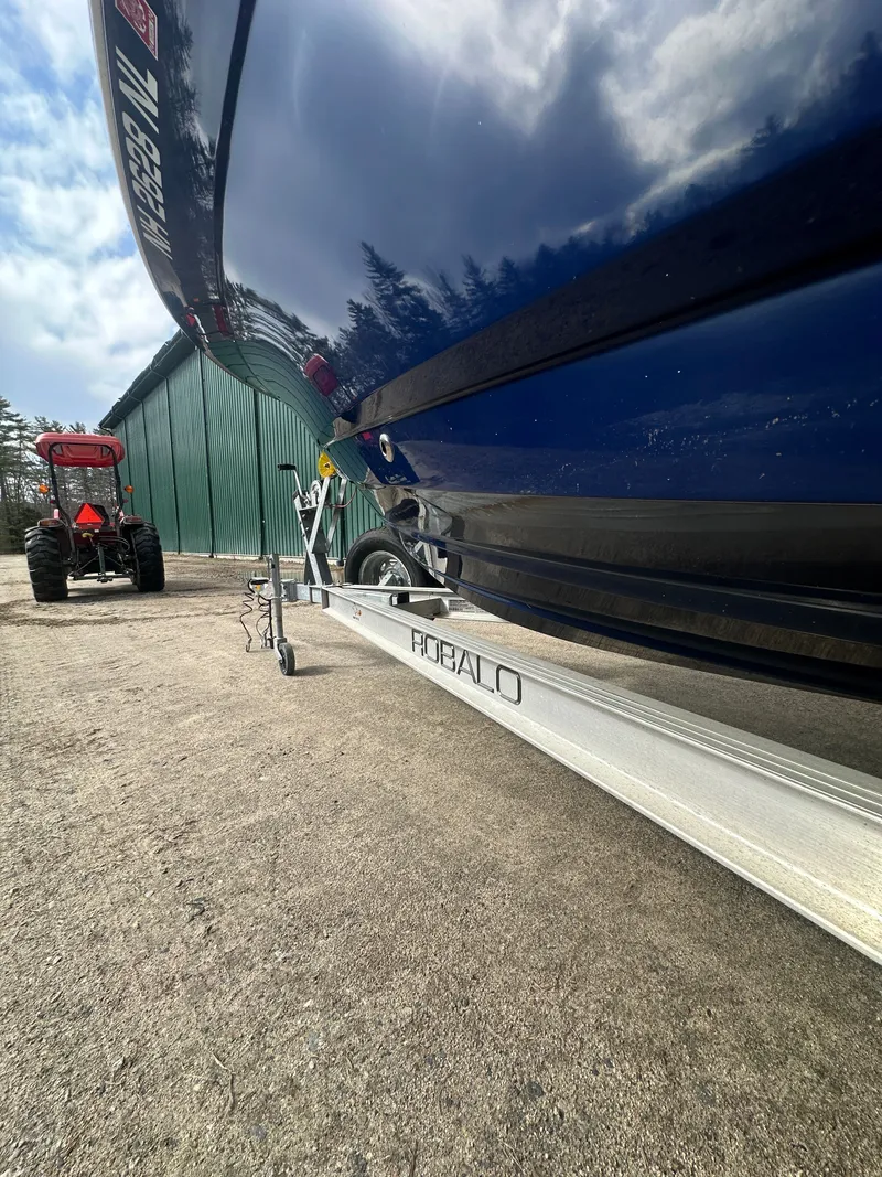 Slide: The Image of 2023 Robalo R202 Explorer on trailer beside tractor. - 4