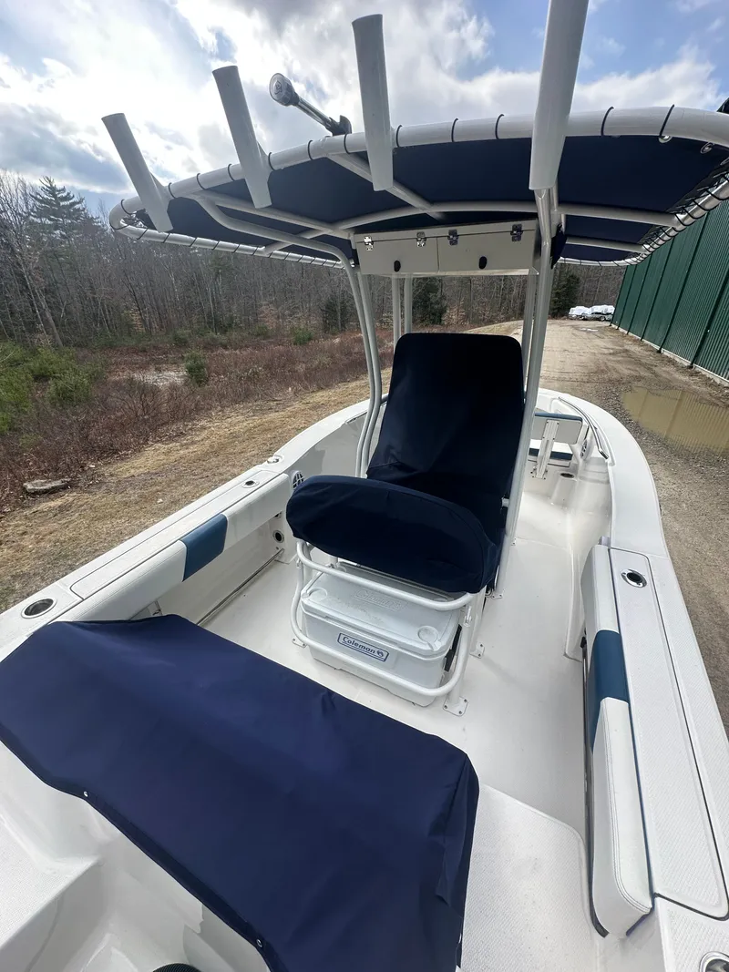 Slide: The Image of 2023 Robalo R202 Explorer boat with blue covers outdoors. - 5