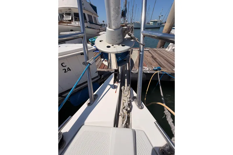 Slide: The Image of Sailboat deck view of a 1999 Catalina 320 docked at a marina. - 11