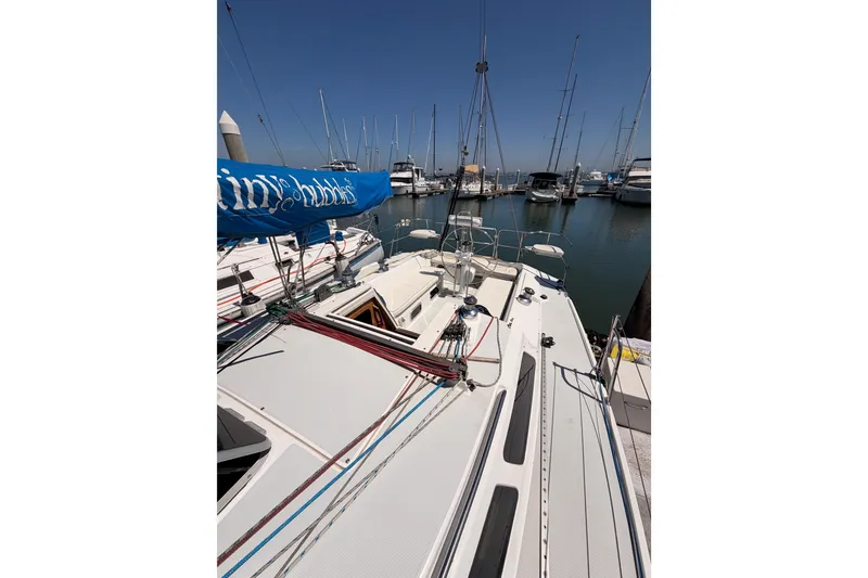 Slide: The Image of Sailboat Catalina 320, 1999 model, docked in a marina with clear blue skies. - 14
