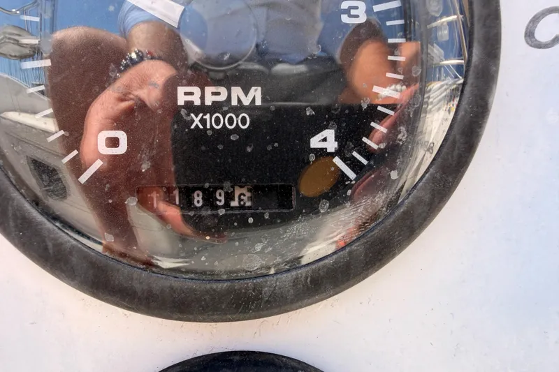 Slide: The Image of Close-up of a Catalina 320 tachometer showing 1896 RPM, model year 1999. - 19