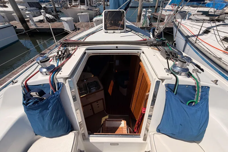 Slide: The Image of Cockpit view of a 1999 Catalina 320 sailboat docked at a marina. - 22