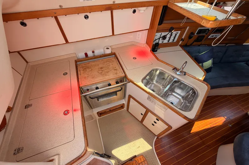 Slide: The Image of Interior of a 1999 Catalina 320 sailboat kitchen with stove and double sink. - 24