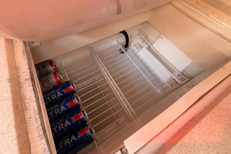 Slide: The Image of Built-in cooler on 1999 Catalina 320 yacht with beer cans inside. - 27