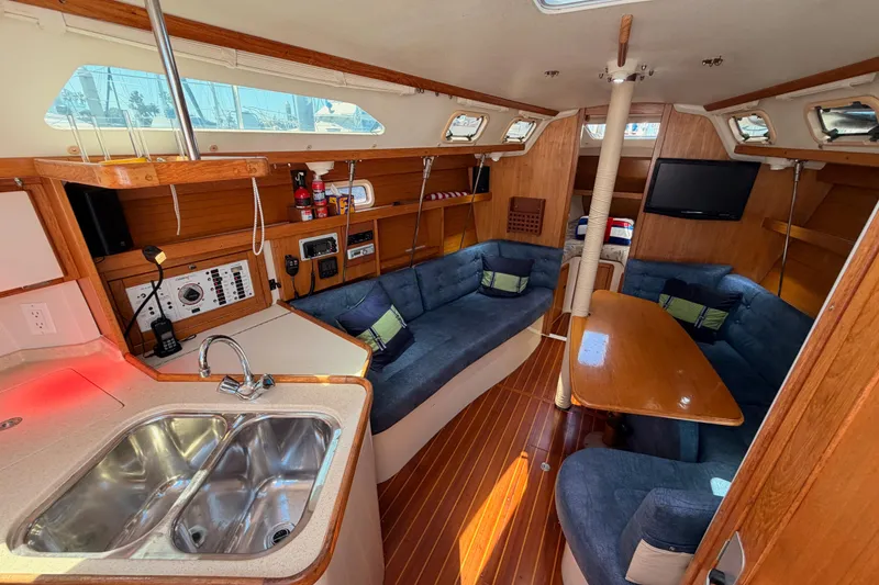 Slide: The Image of Interior of a 1999 Catalina 320 sailboat with cozy seating and modern amenities. - 36