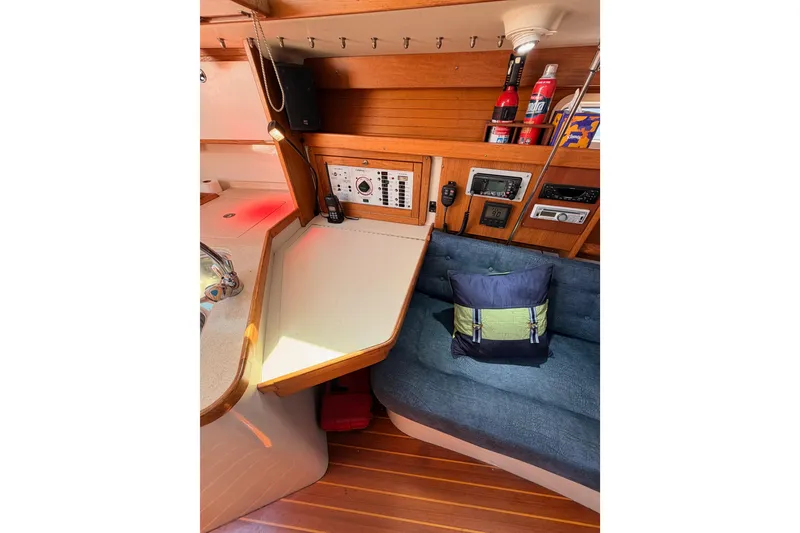 Slide: The Image of Interior of a 1999 Catalina 320 sailboat with navigation station and seating area. - 38