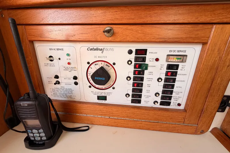 Slide: The Image of Control panel of a 1999 Catalina 320 yacht with radio and electrical switches. - 39
