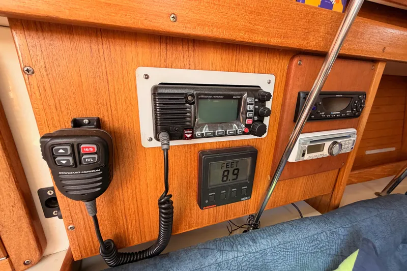 Slide: The Image of Control panel of a 1999 Catalina 320 sailboat with radio and depth gauge. - 40