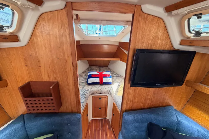 Slide: The Image of Interior of a 1999 Catalina 320 sailboat with cozy cabin and mounted TV. - 43