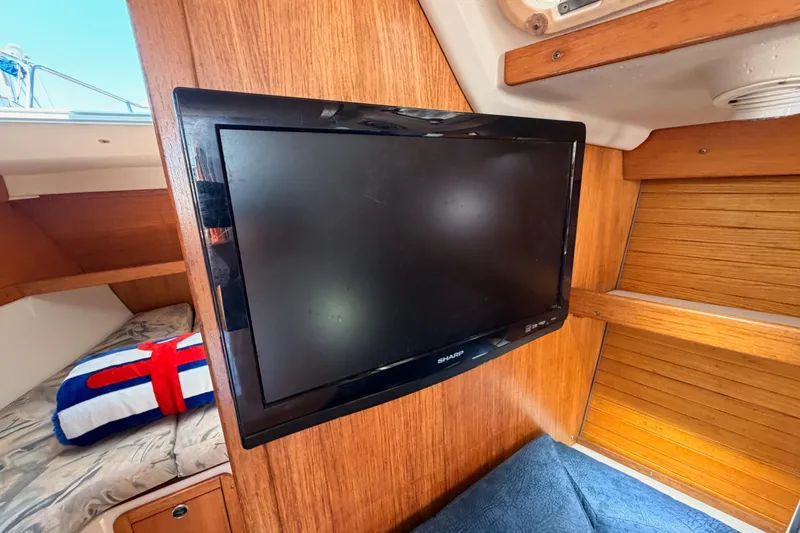 Slide: The Image of Flat-screen TV mounted in a 1999 Catalina 320 sailboat cabin interior. - 44