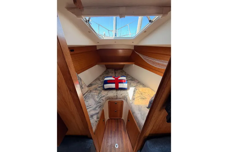 Slide: The Image of Interior cabin of a 1999 Catalina 320 sailboat with a skylight and cozy bedding. - 46