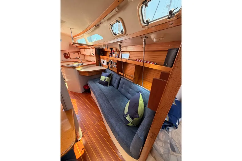 Slide: The Image of Interior of a 1999 Catalina 320 sailboat with cozy seating and wooden accents. - 49