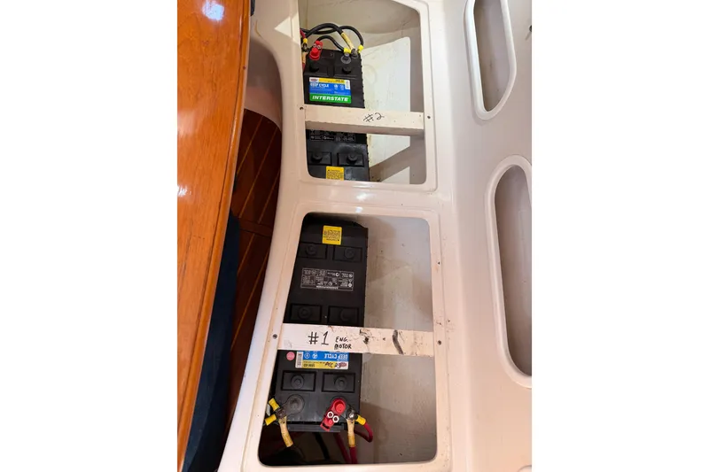 Slide: The Image of Battery compartment of a 1999 Catalina 320 sailboat with labeled batteries. - 55