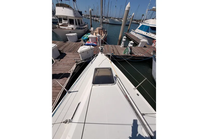 Slide: The Image of Sailboat Catalina 320, 1999 model, docked at marina with clear blue sky. - 9