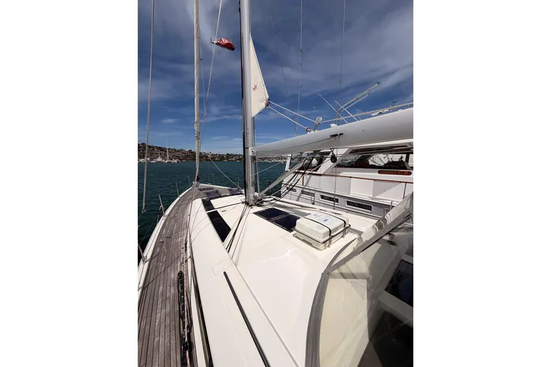 Slide: The Image of 2020 Beneteau Oceanis 51.1 yacht deck with sails, on calm waters under blue sky. - 11