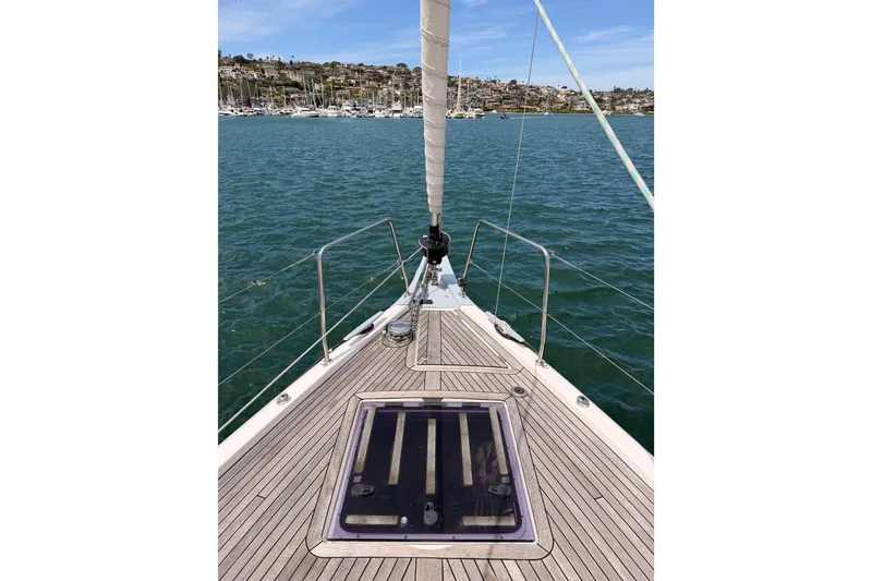 Slide: The Image of Beneteau Oceanis 51.1 sailboat deck, 2020 model, on calm waters with marina view. - 13