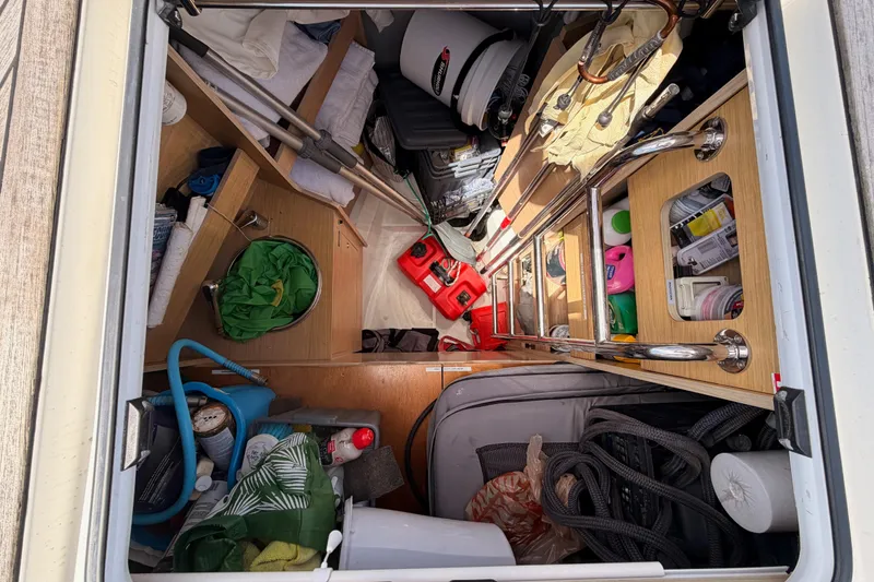 Slide: The Image of Storage compartment of a 2020 Beneteau Oceanis 51.1 yacht, filled with various equipment and supplies. - 14