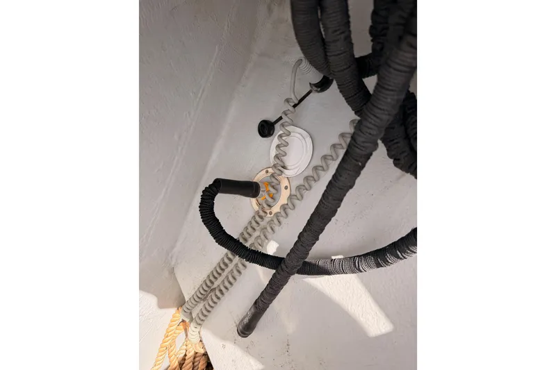 Slide: The Image of Close-up of coiled ropes and cables on a 2020 Beneteau Oceanis 51.1 sailboat. - 17