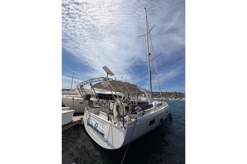 Slide: The Image of 2020 Beneteau Oceanis 51.1 yacht docked under a partly cloudy sky. - 2