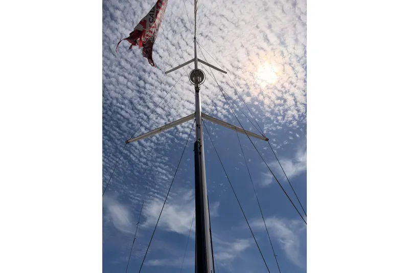 Slide: The Image of Mast of 2020 Beneteau Oceanis 51.1 sailboat against a cloudy sky. - 22