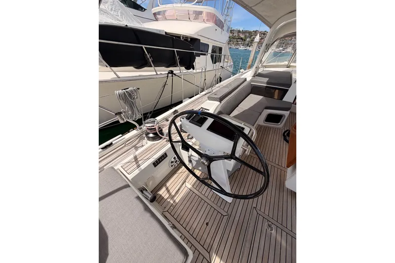 Slide: The Image of Cockpit of 2020 Beneteau Oceanis 51.1 yacht with steering wheel and seating area. - 31