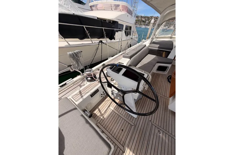 Slide: The Image of 2020 Beneteau Oceanis 51.1 yacht cockpit with steering wheel and seating, docked at marina. - 32