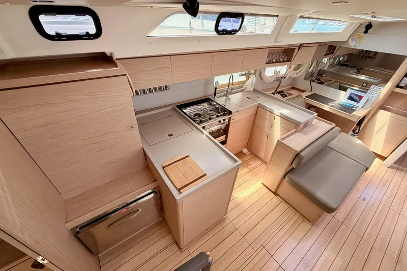 Slide: The Image of Modern kitchen interior of 2020 Beneteau Oceanis 51.1 yacht with sleek wood finish. - 46