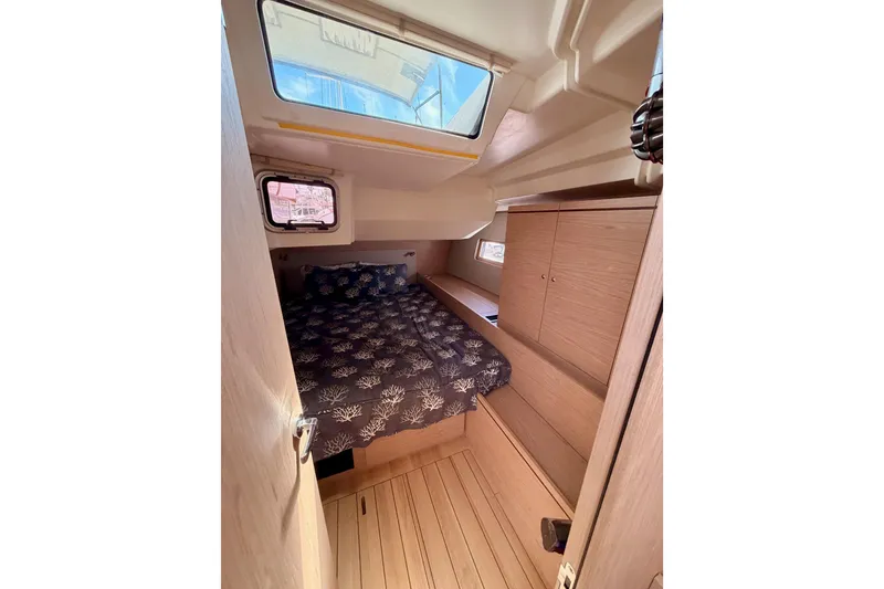 Slide: The Image of Cozy cabin interior of 2020 Beneteau Oceanis 51.1 yacht with bed and wooden cabinetry. - 53