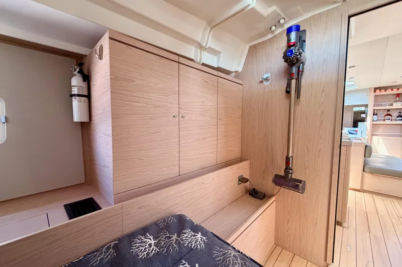 Slide: The Image of Interior of 2020 Beneteau Oceanis 51.1 yacht with modern wood finish and mounted vacuum. - 55