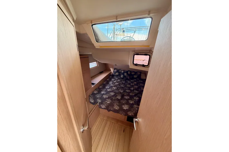 Slide: The Image of Cozy cabin interior of 2020 Beneteau Oceanis 51.1 yacht with nautical bedding. - 59
