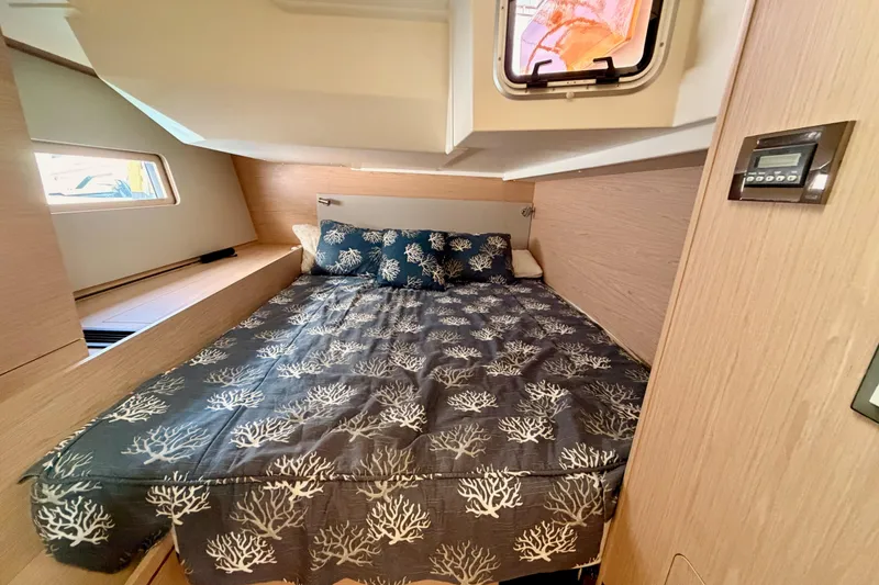 Slide: The Image of Cozy cabin interior of 2020 Beneteau Oceanis 51.1 yacht with stylish bedding and natural light. - 60
