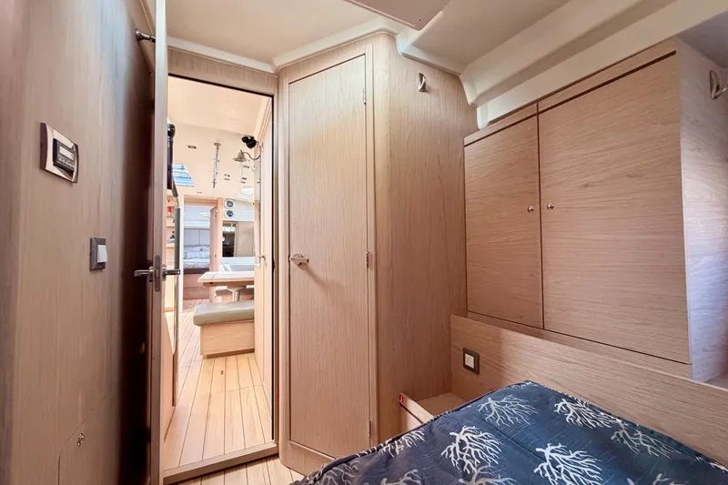 Slide: The Image of Interior of 2020 Beneteau Oceanis 51.1 yacht, featuring cozy cabin and modern wood finishes. - 61