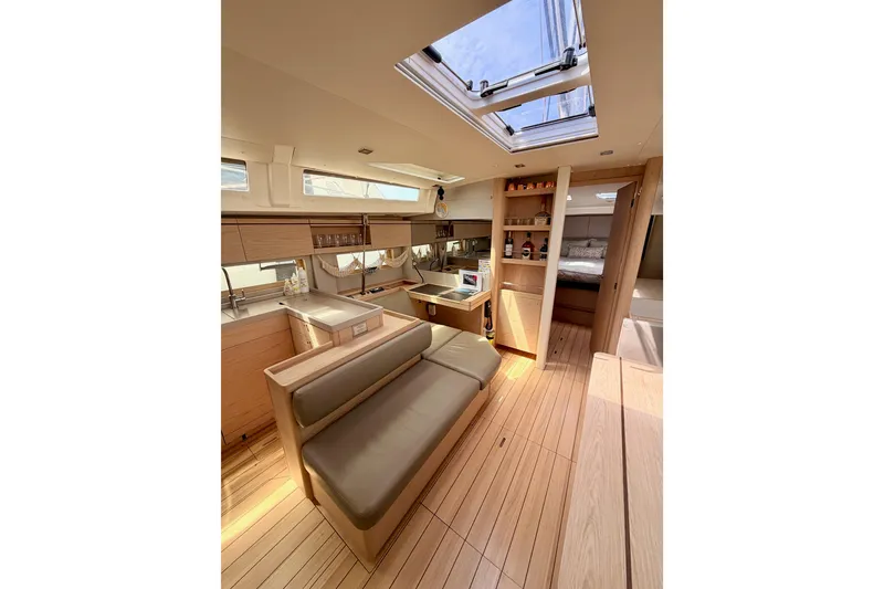 Slide: The Image of Luxurious interior of 2020 Beneteau Oceanis 51.1 yacht with modern furnishings and skylight. - 64
